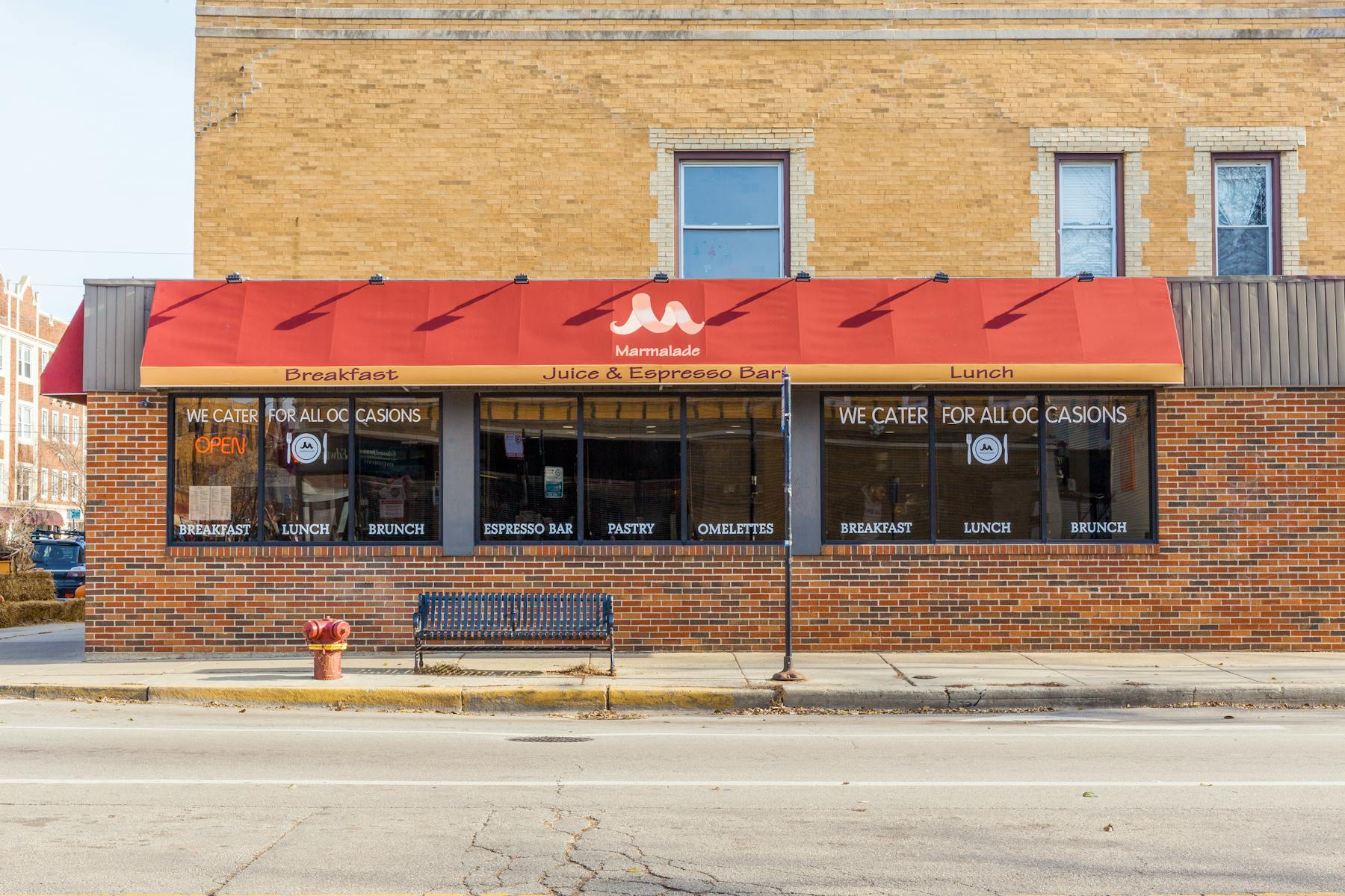 a large brick building with a store on the side of a road